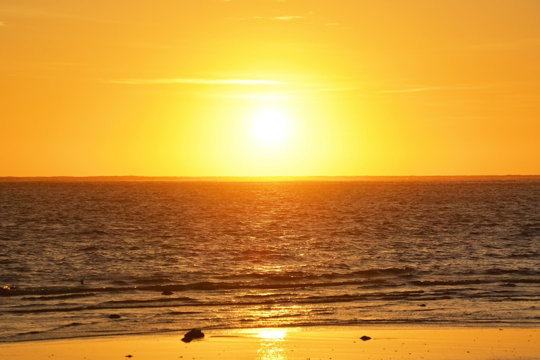 body of water during sunset