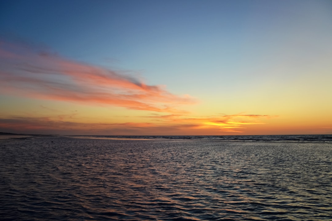 body of water during sunset