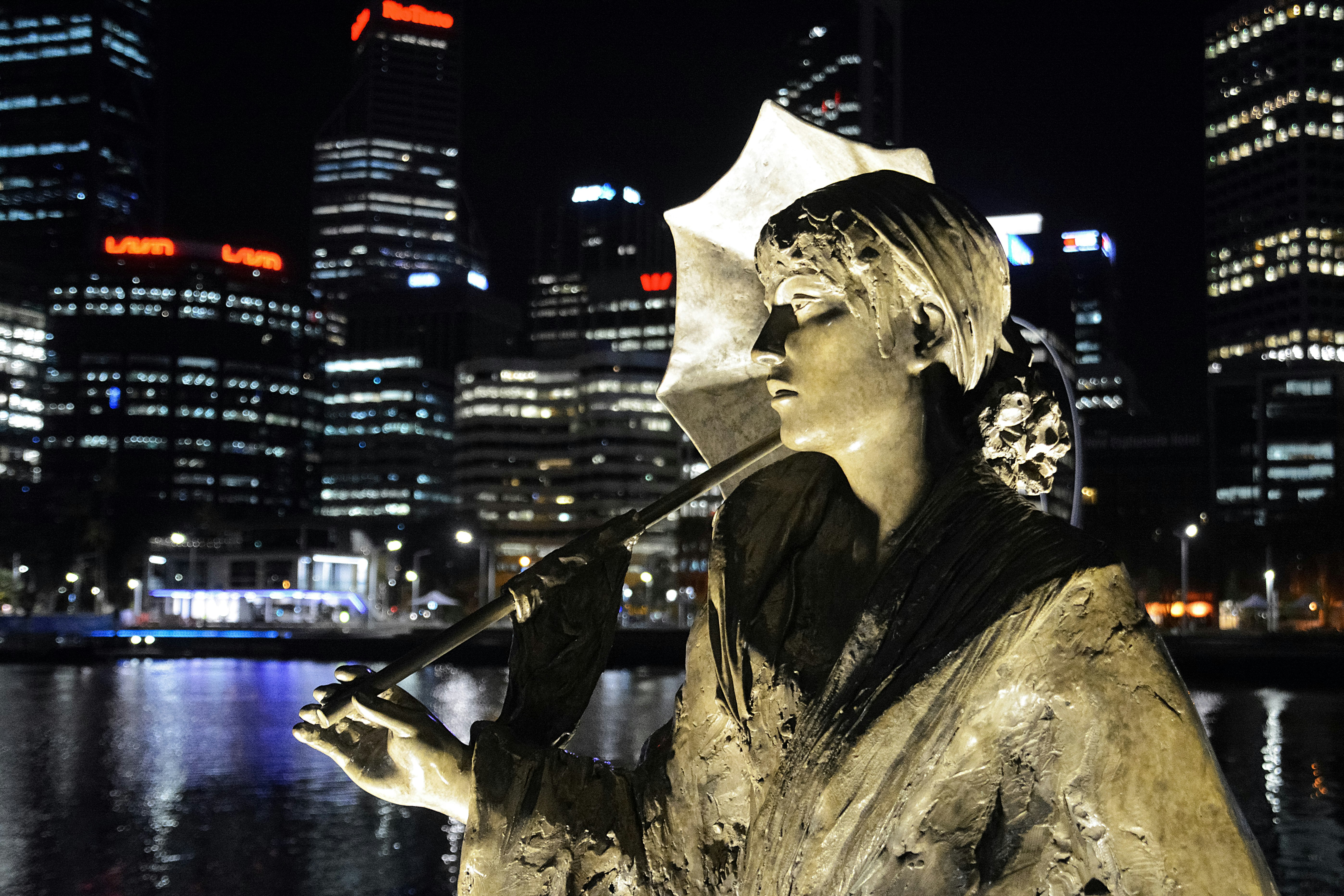 man in black shirt holding a guitar statue