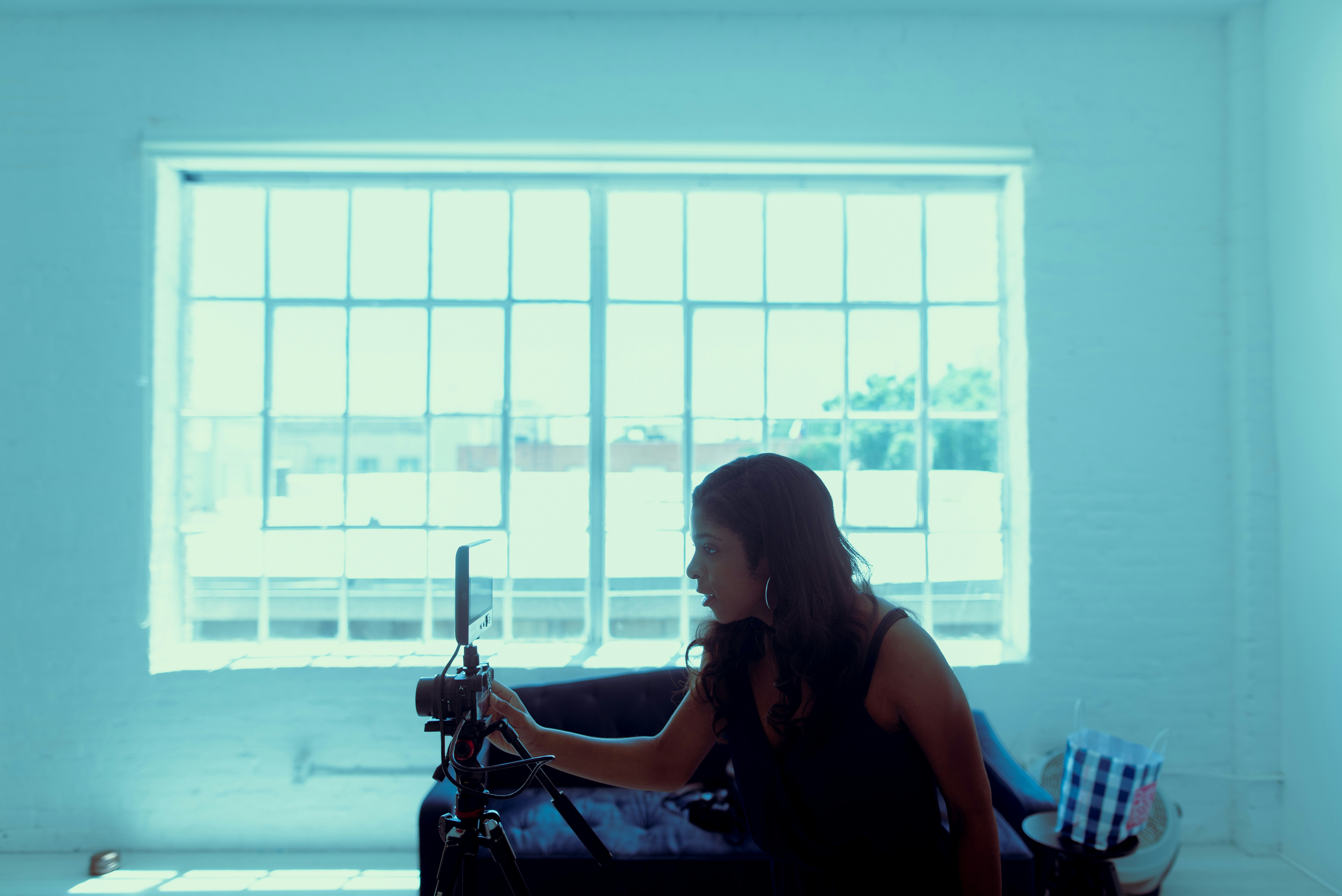 woman in black tank top sitting on chair