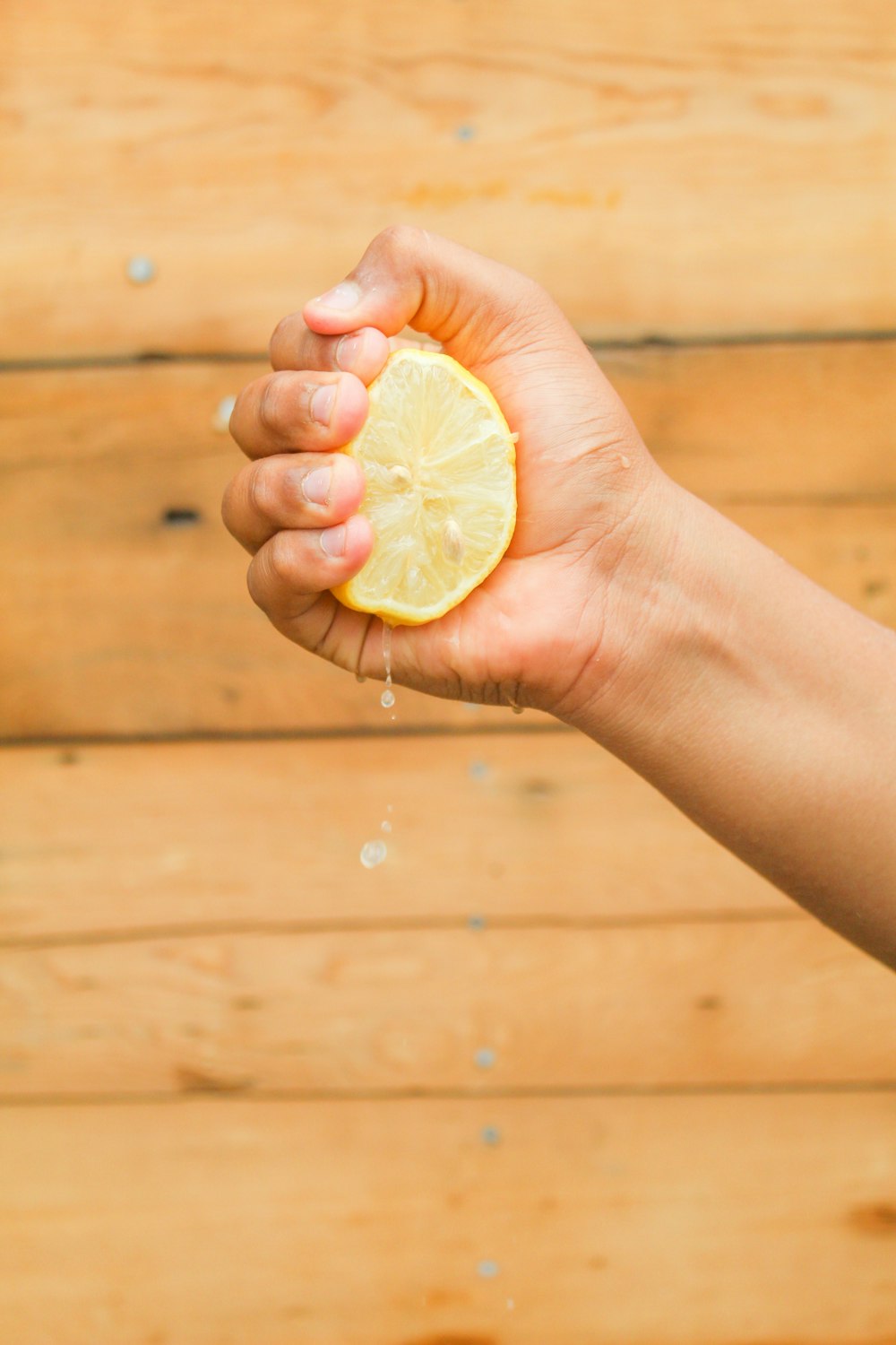 person holding sliced lemon fruit