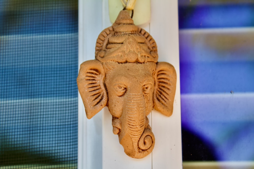 gold buddha figurine on white table