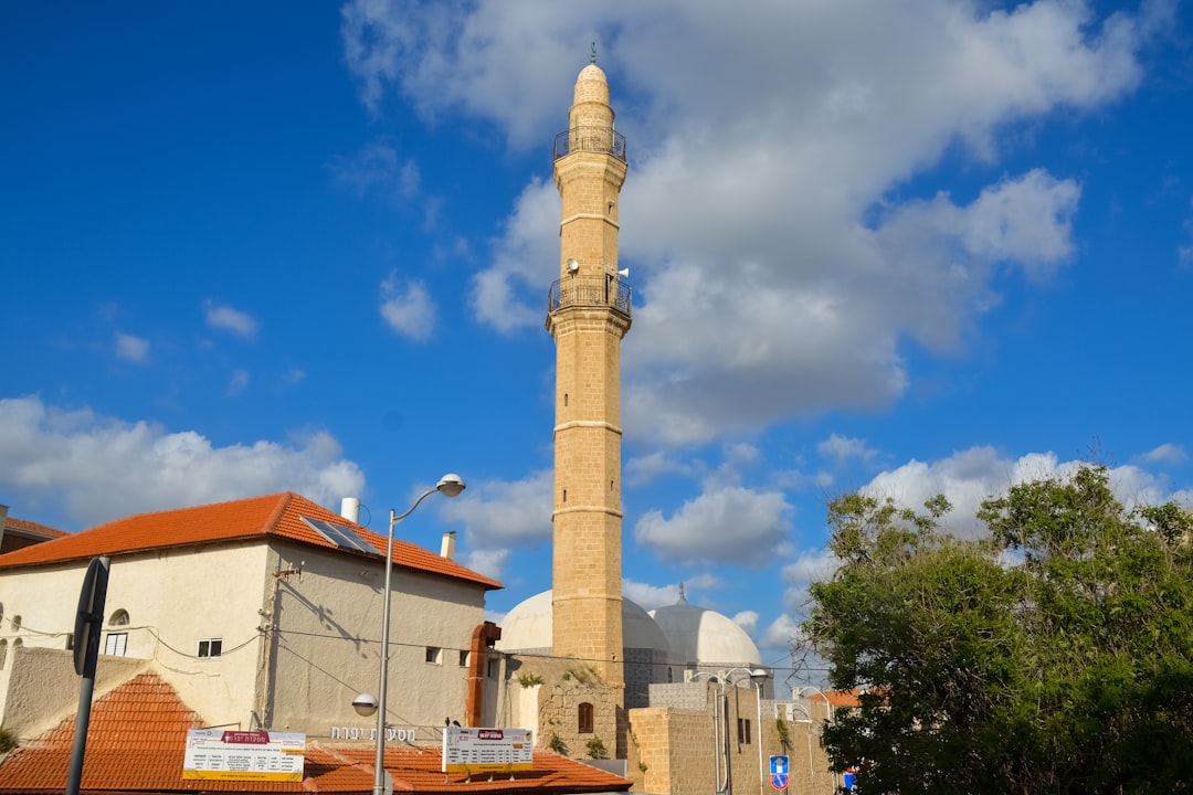 brown and white concrete building under blue sky during daytime