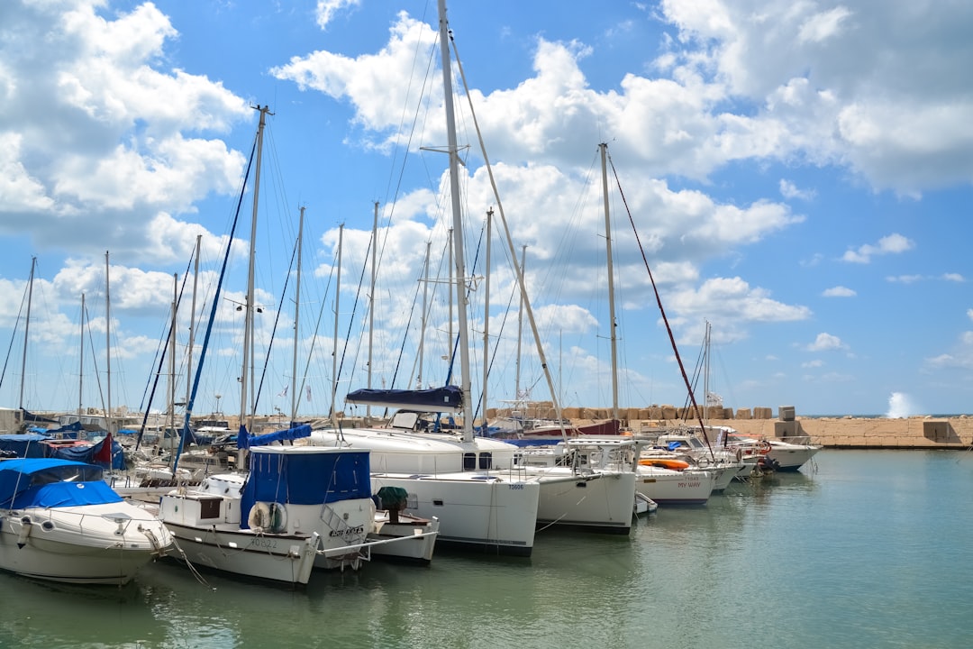 white and blue boats on sea under blue sky during daytime