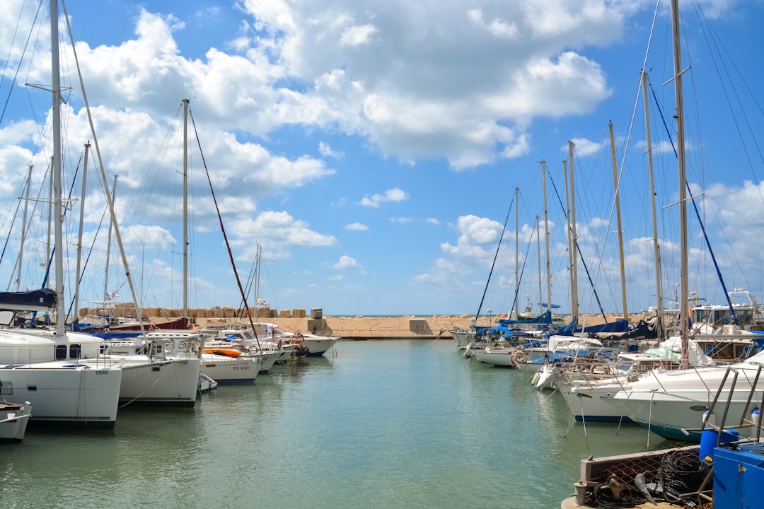 white boats on sea dock under blue sky during daytime