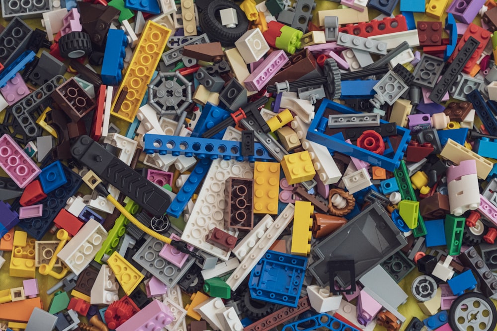 assorted plastic toy blocks on white table