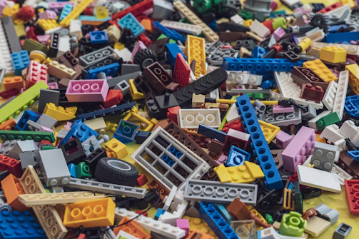 A volunteer sorting sanitized LEGO pieces into organized bins.
