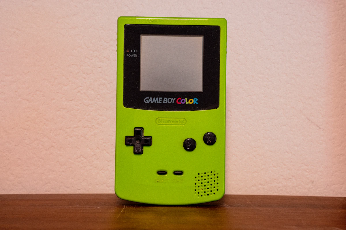Neon green Nintendo Game Boy Color standing upright on a wood surface