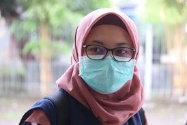 woman in pink hijab and black long sleeve shirt