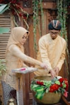woman in yellow long sleeve shirt holding bouquet of flowers
