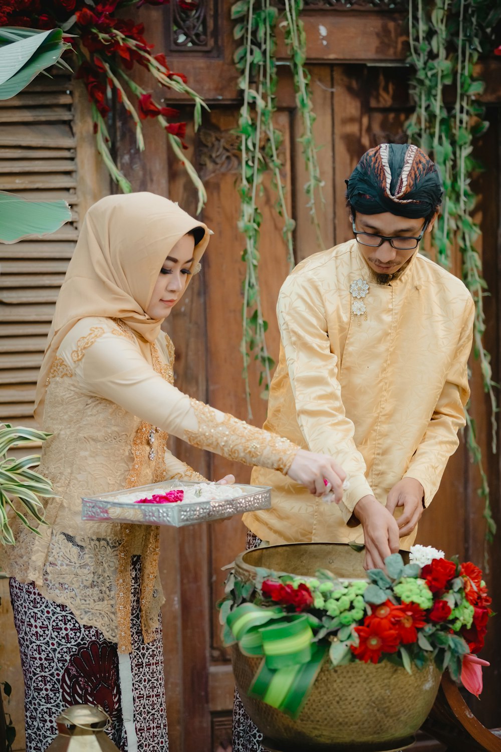 woman in yellow long sleeve shirt holding bouquet of flowers