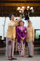 woman in yellow long sleeve shirt standing beside woman in purple and white dress