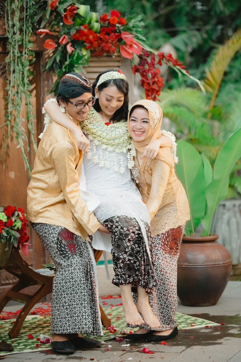 2 women sitting on brown wooden bench