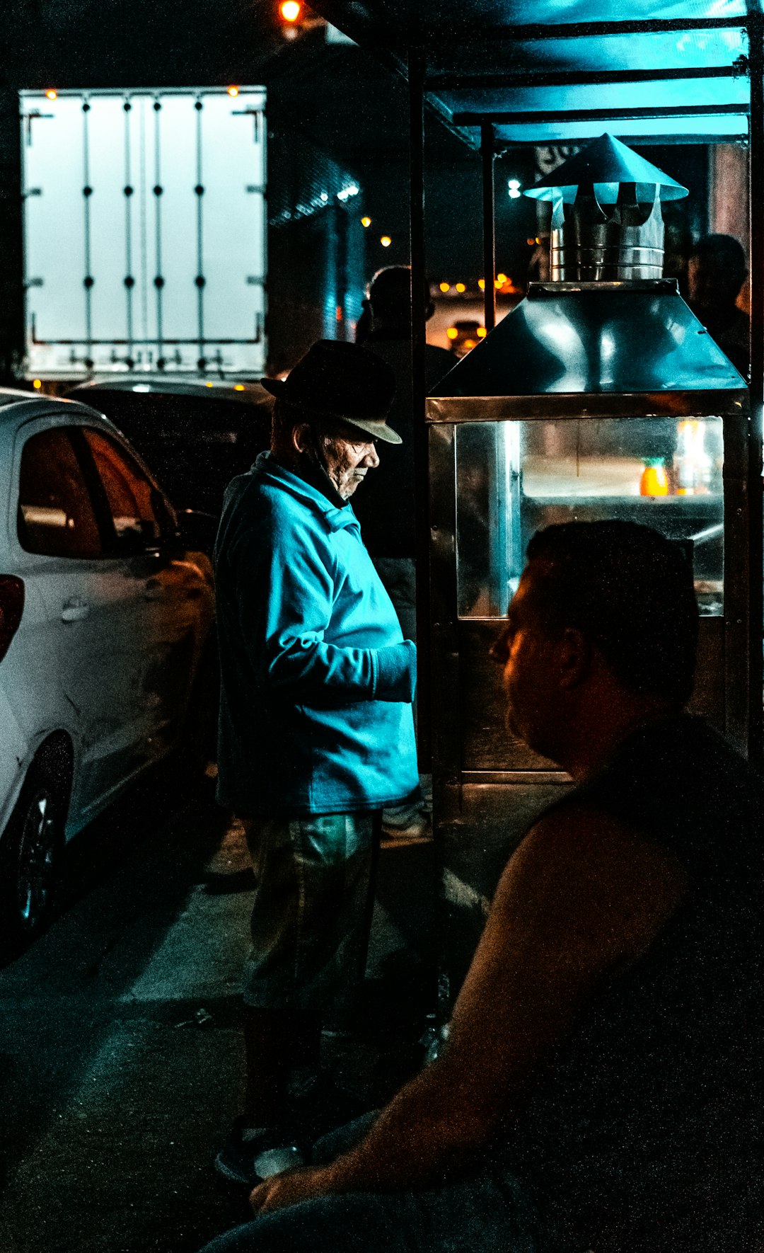 man in blue shirt standing beside woman in black shirt