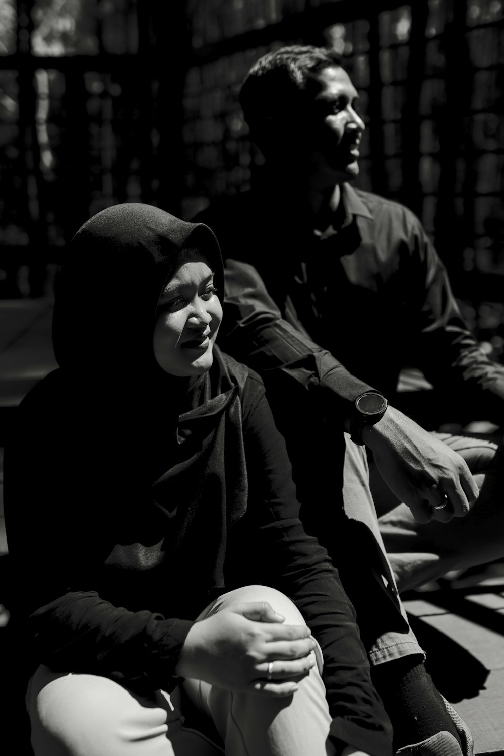 woman in black hoodie sitting on bench