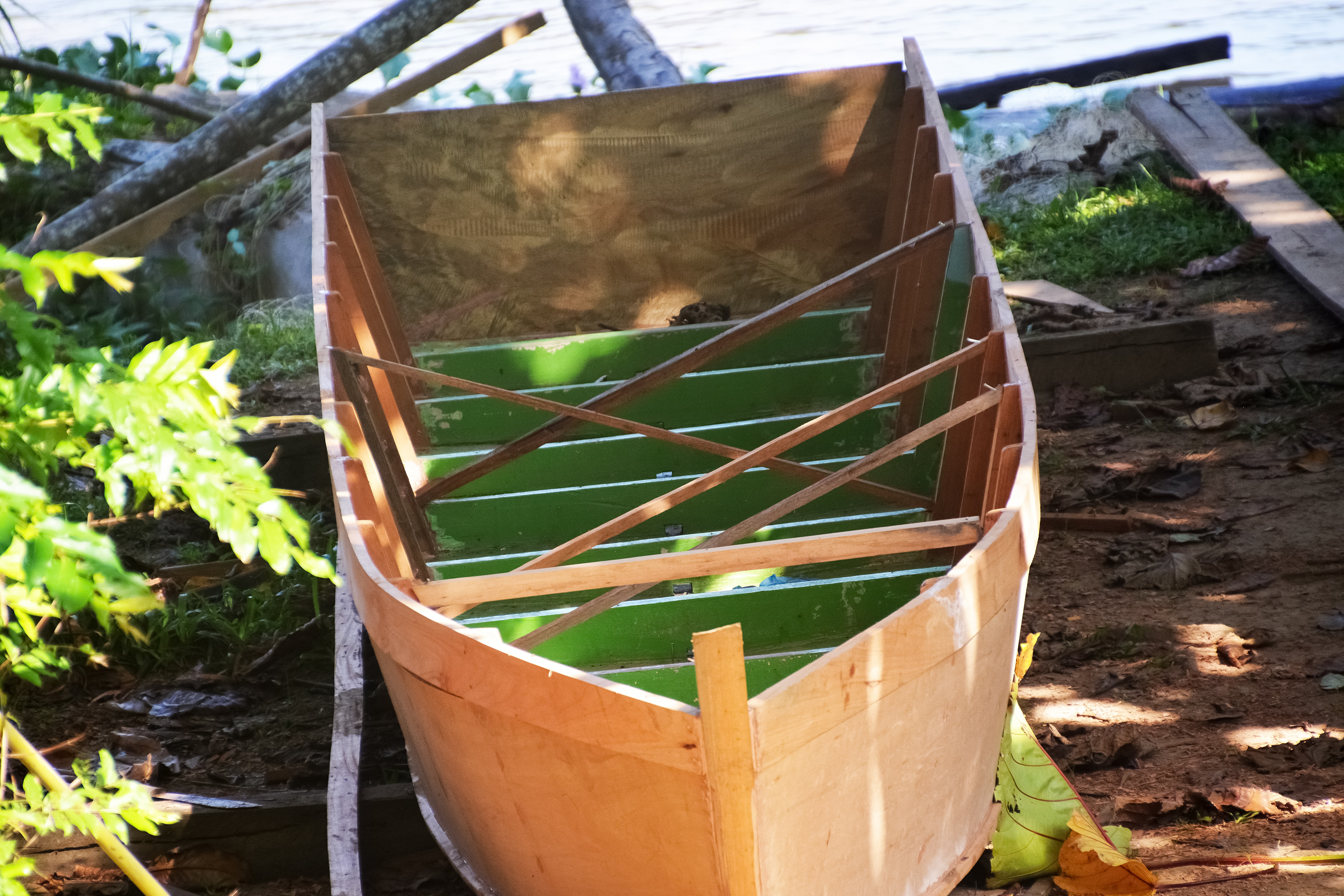 brown wooden boat on green grass during daytime