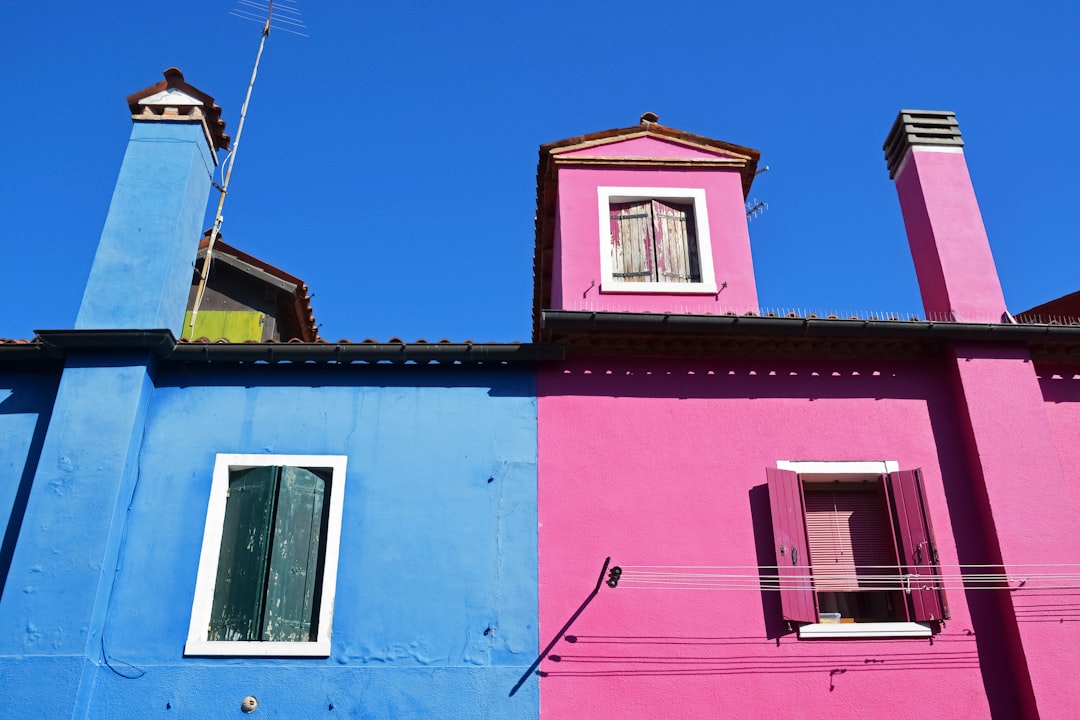 pink and white concrete building under blue sky during daytime