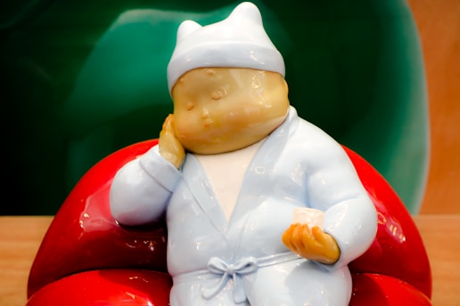 baby in white dress ceramic figurine