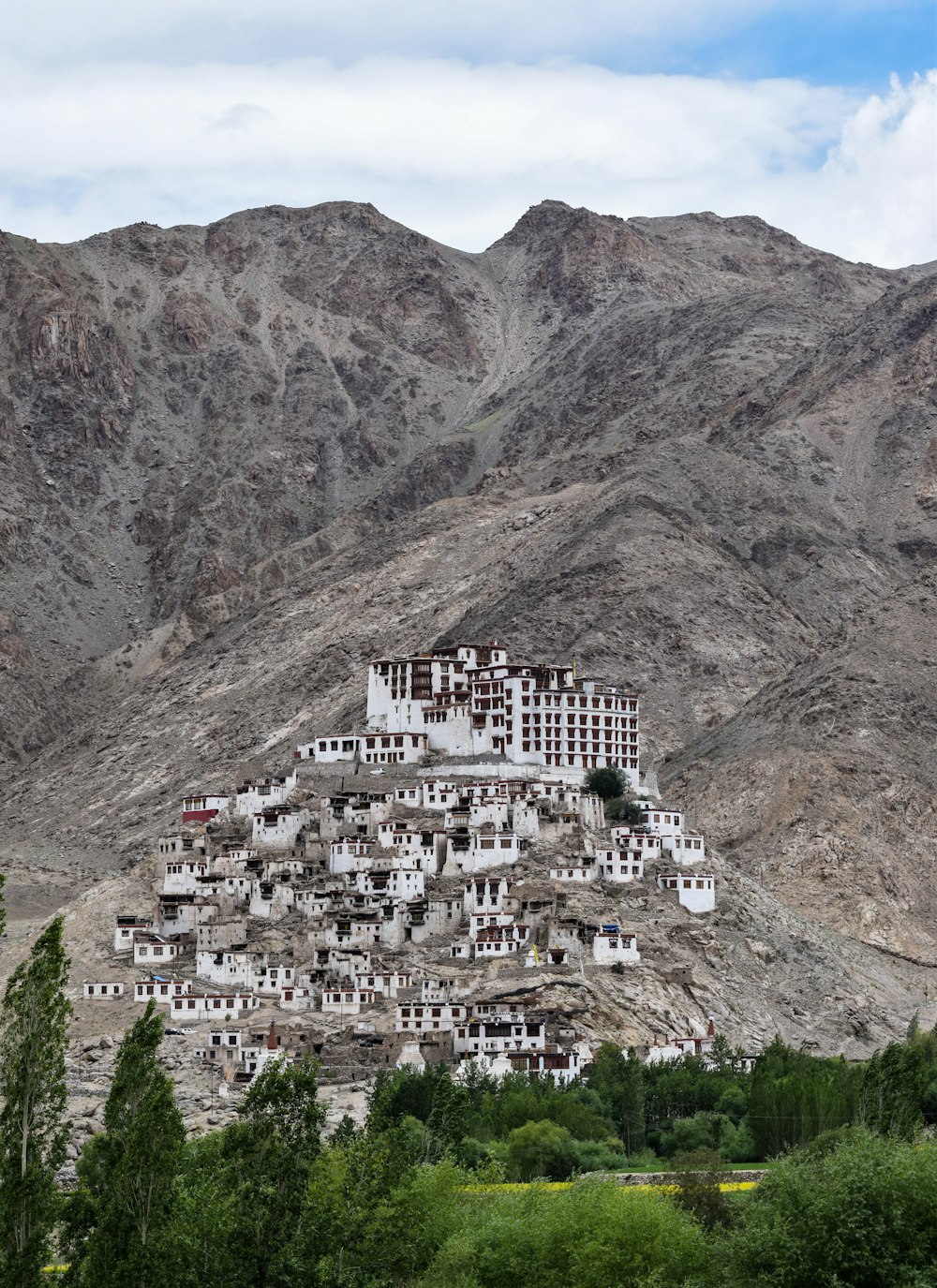 white concrete building near mountain during daytime