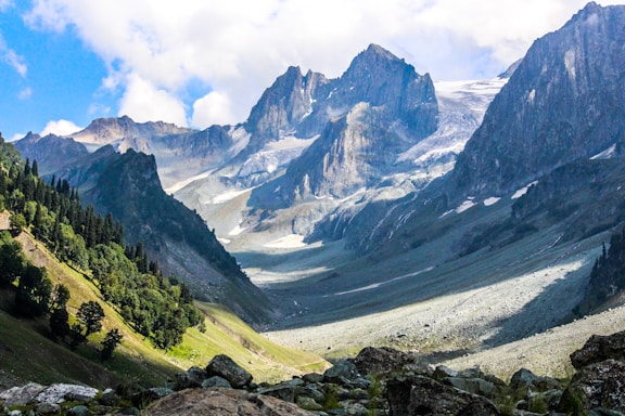 green and gray mountains under white clouds during daytime