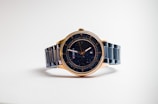 silver and gold round analog watch