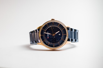 silver and gold round analog watch