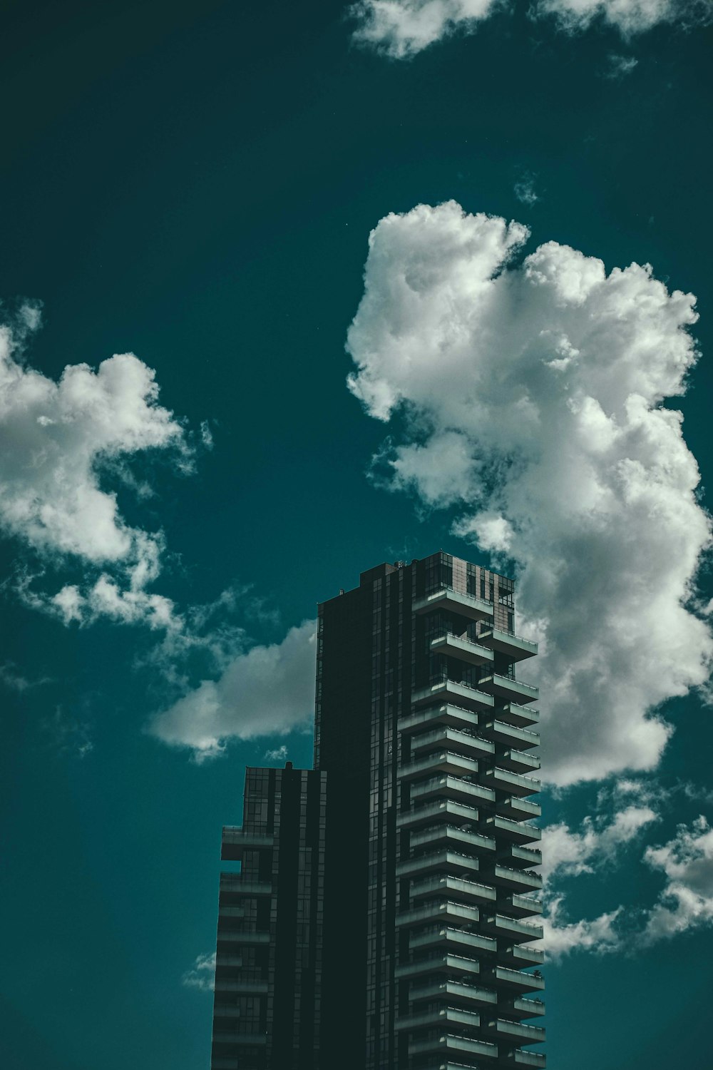 white clouds over city buildings during daytime