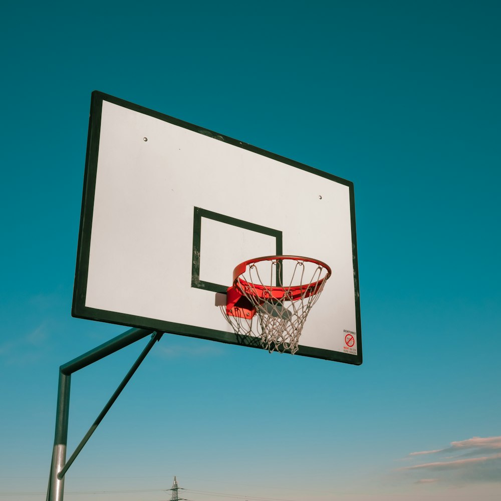 white and black basketball hoop under blue sky during daytime