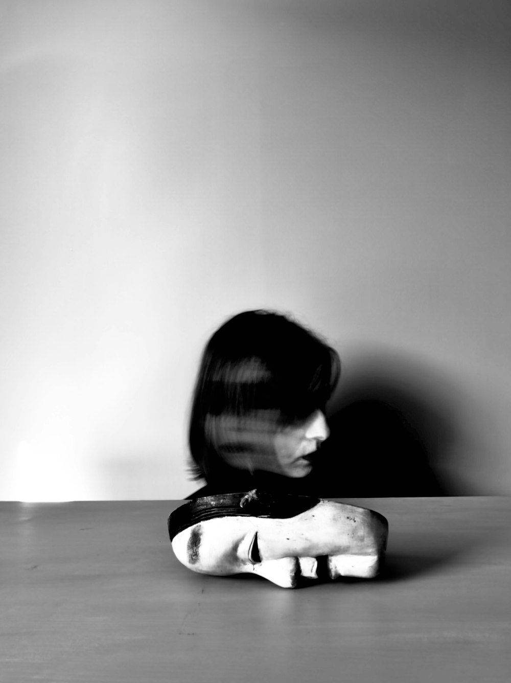 grayscale photo of child sitting on floor