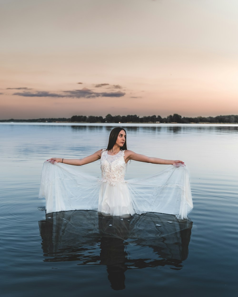 woman in white dress standing on water during daytime