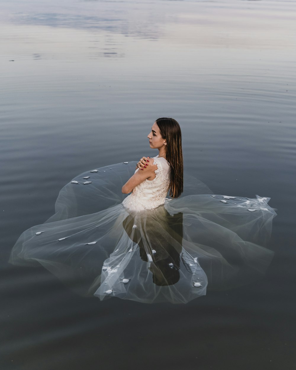 woman in white dress sitting on white textile