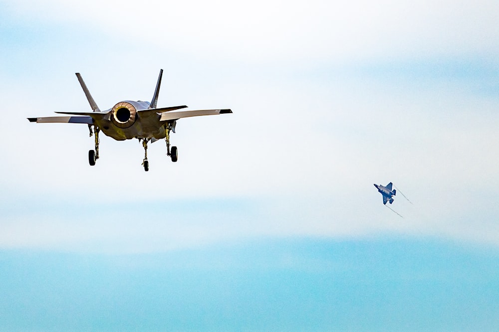 yellow and black plane in mid air during daytime