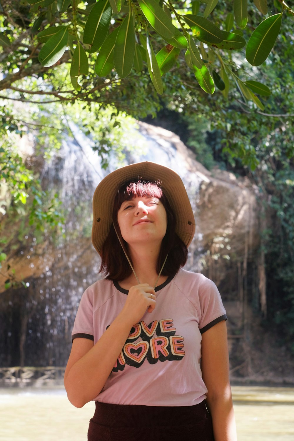 woman in white crew neck t-shirt wearing brown hat