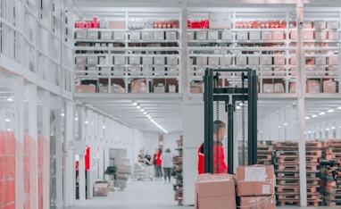 man in black pants and black jacket standing on black and red fork lift