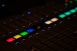 Mixing console with colorful sound levels glowing.