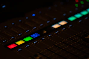 Mixing console with colorful sound levels glowing.