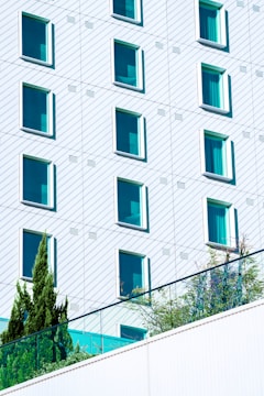 white concrete building with blue windows
