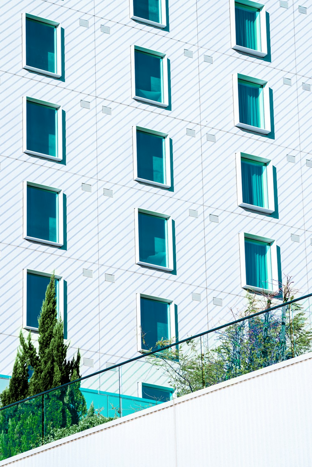 white concrete building with blue windows