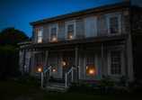 Evening scene of guest house exterior softly lit against darkening sky.