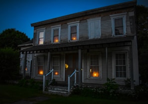 Evening scene of guest house exterior softly lit against darkening sky.