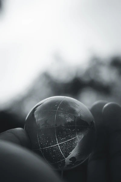 grayscale photo of person holding ball