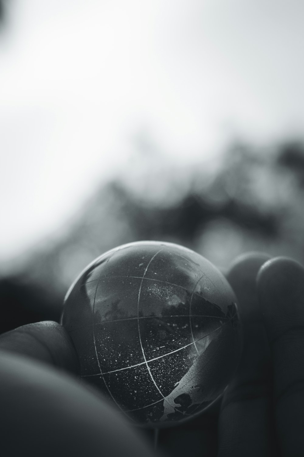grayscale photo of person holding ball