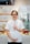 woman in white scrub suit holding a cup of coffee