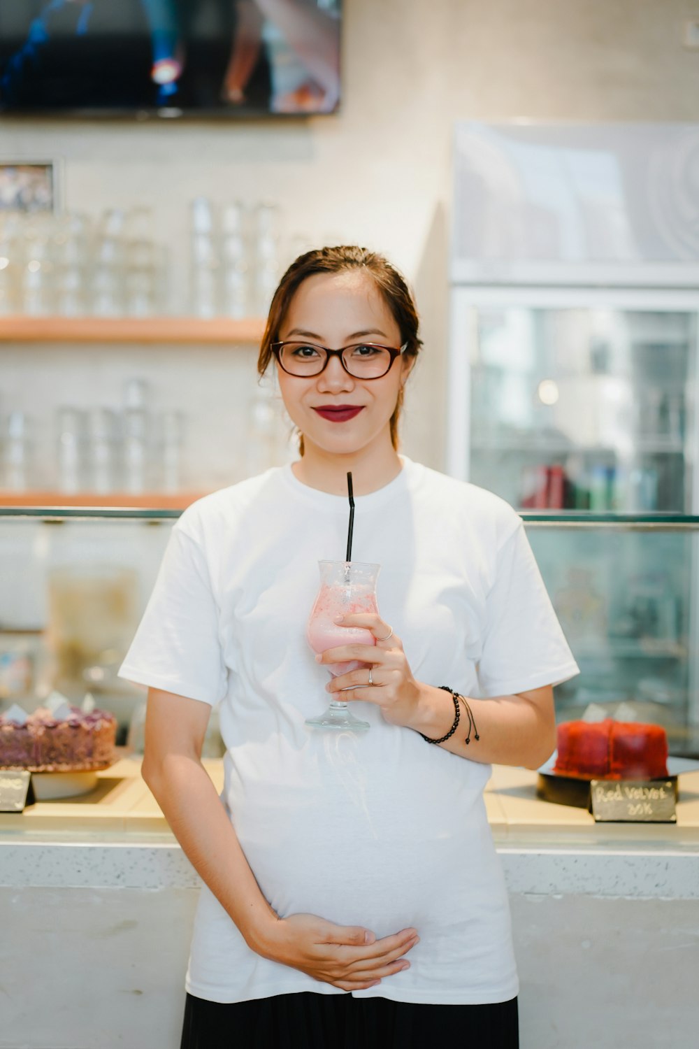 woman in white scrub suit holding a cup of coffee