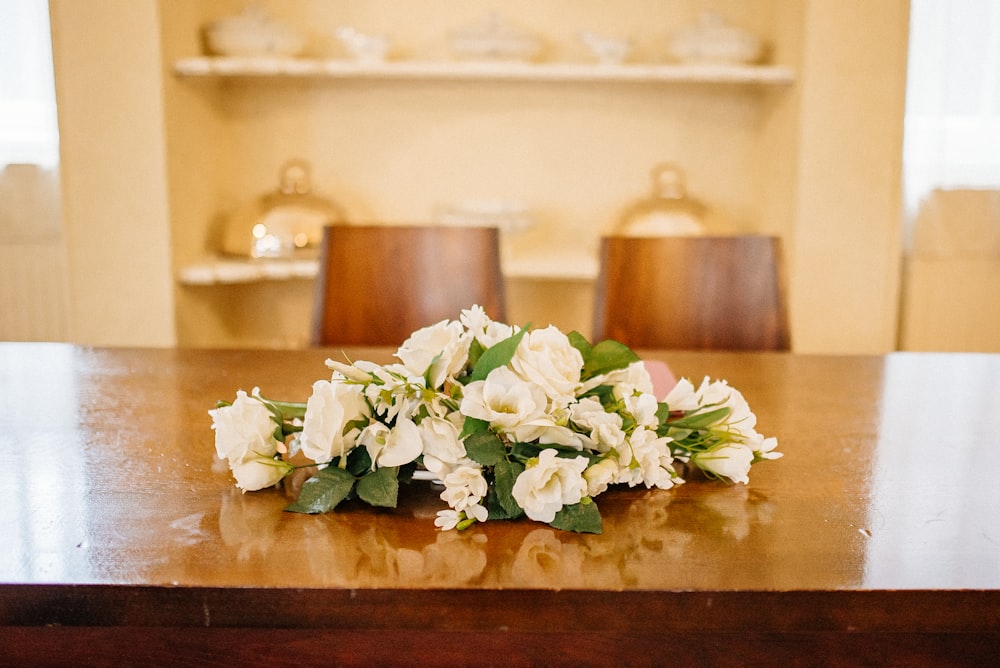 white flowers on brown wooden table