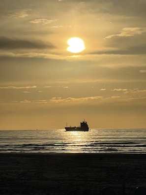 Sunset view over the horizon with a Goldenstone ship silhouetted against the sky.