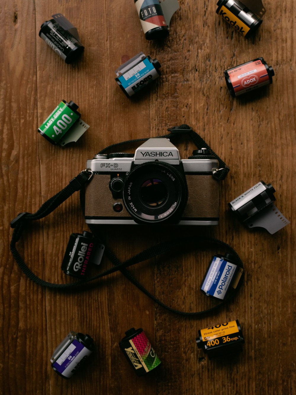 black and silver canon dslr camera on brown wooden table