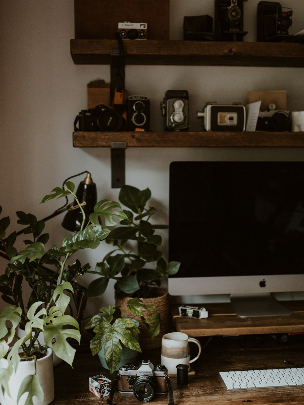 silver imac on brown wooden table