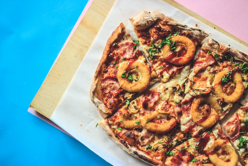 pizza on brown wooden tray