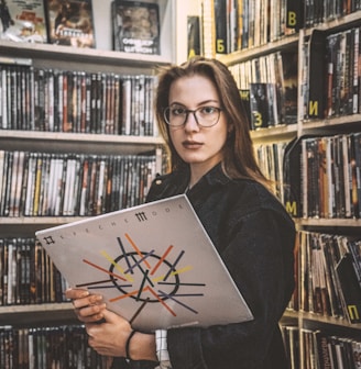 woman in black long sleeve shirt holding book